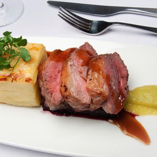 Roasted Cornish rump of lamb parsley pom puree Blue cheese Bon bon, red wine jus